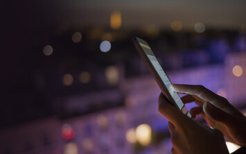 Hand using mobile phone