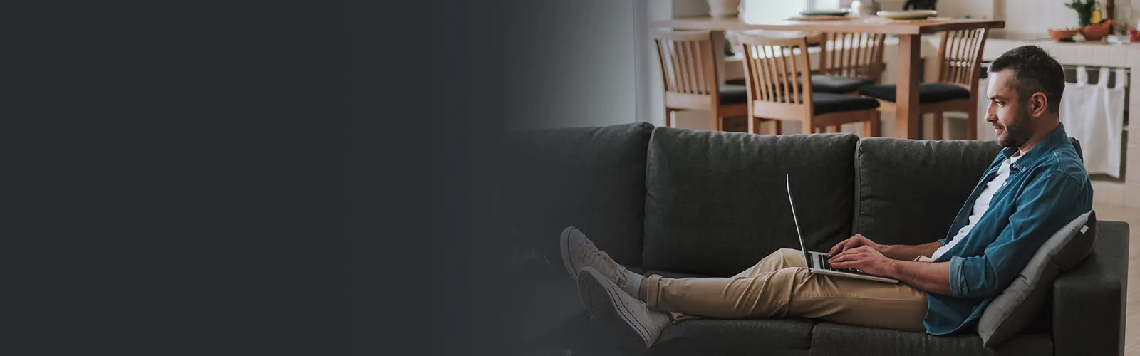 Man on couch working on laptop