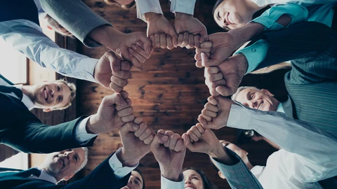 Group of people in circle with fists all in