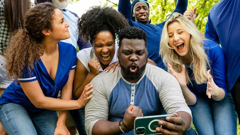 Group of fans watching game on cell phone