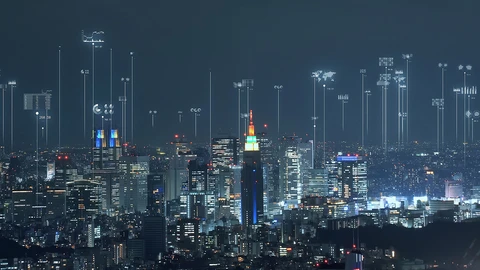 City with skyscrapers lite up at night.