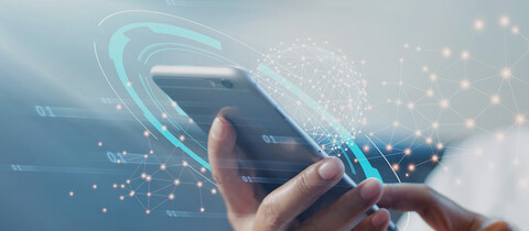 Hand holding mobile phone with abstract security overlays