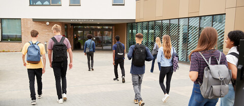 Kids walking into school building