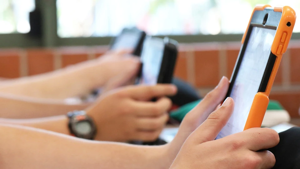 Students holding tablets