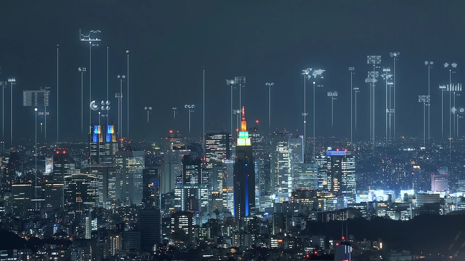 City with skyscrapers lite up at night.